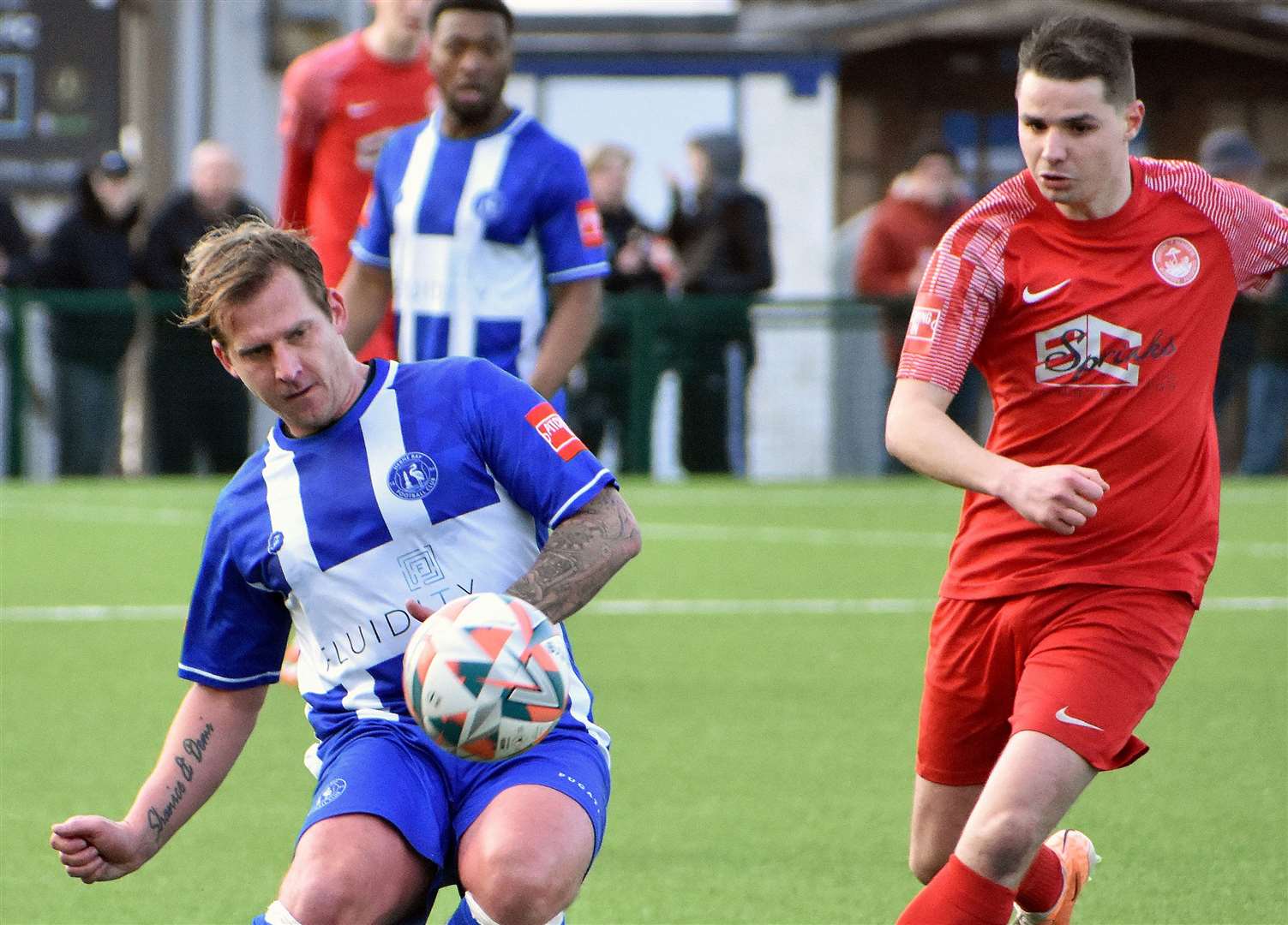 Herne Bay midfielder Danny Walder is closed down by Hythe forward Jake Embery in Bay’s 2-1 defeat at Winch’s Field on Saturday. Picture: Randolph File