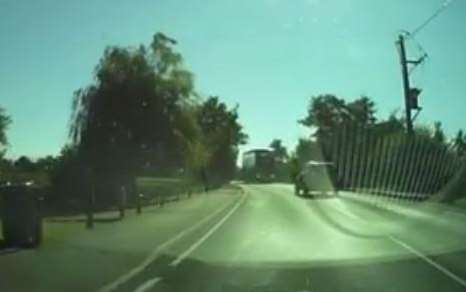 Jeep driver almost hits bus as he attacks the right hand lane on a bend at a hill.