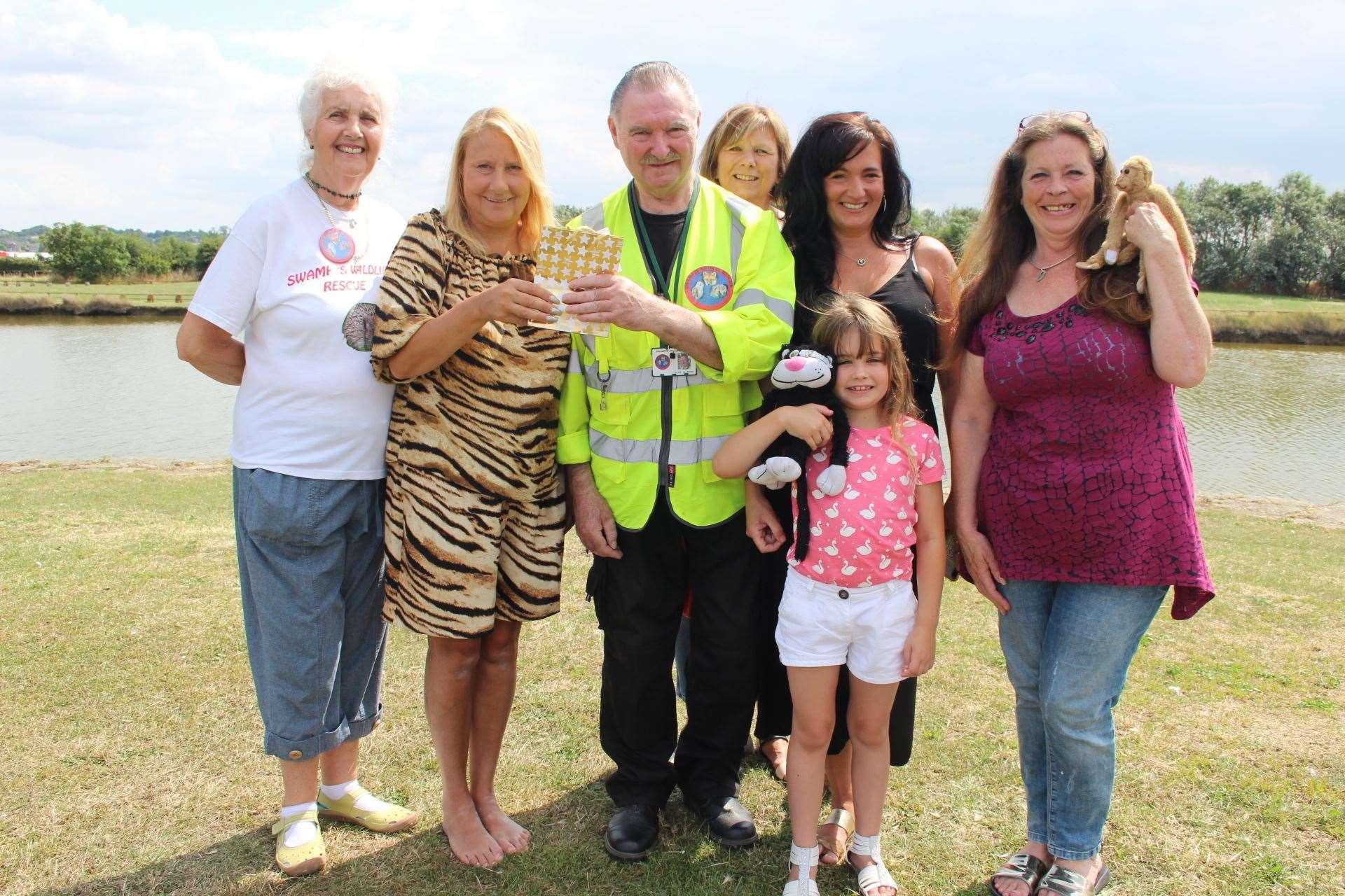 Ray Allibone of Swampy Wildlife Rescue receives a donation from Mandy Bower of the Asda night team, Sittingbourne, after rescuing an attacked swan at Barton's Point, Sheerness. Also in the picture are Patricia Lassnig, Adele Stearns, her daughter Lola, and Lyn Burr (14785355)