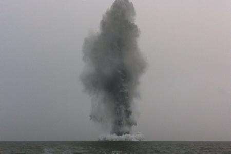 Navy divers carry out a controlled explosion