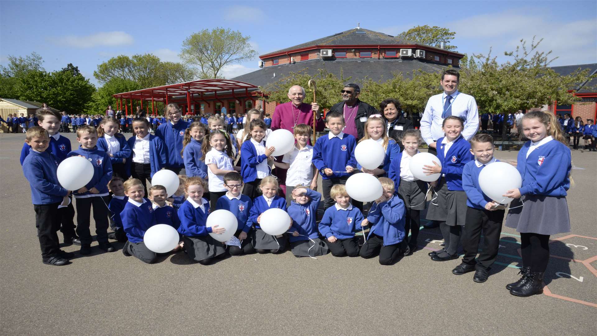 Bishop Trevor Willmott with The Most Rev Ian Ernest, Archbishop of the Indian Ocean, Mrs Kamla Ernest and head teacher Howard Fisher with the Worship Warriors before the balloon release at St George's primary.