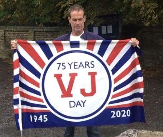 Darenth Parish Cllr Tom Hicks raised the VJ flag outside St Margarets on behalf of the Parish Council. Picture: David Mote