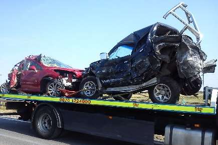 Wrecked vehicles being taken away from the Sheppey Crossing