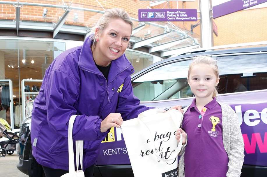 Six year old Paige Wells receives a bag
