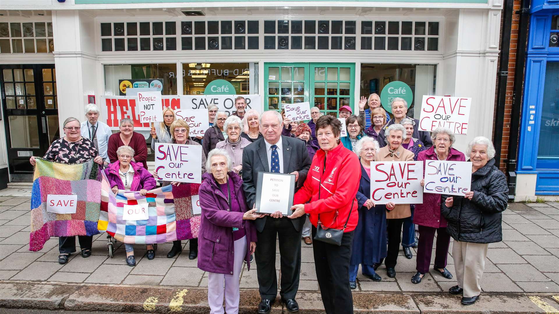 Medway Cllr David Blake receives a petition from Babs Taylor and Lilian Lyons at the Royal Voluntary Service Cafe and Shop in Chatham High Street. Picture: Matthew Walker (1433536)