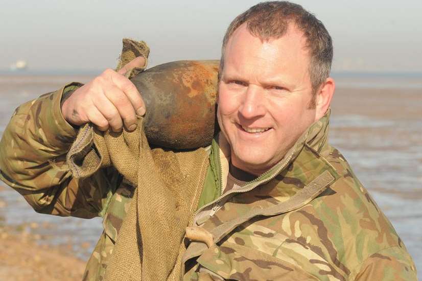 Petty Officer Nobby Clark with one of the unexploded shells. Picture: Steve Crispe