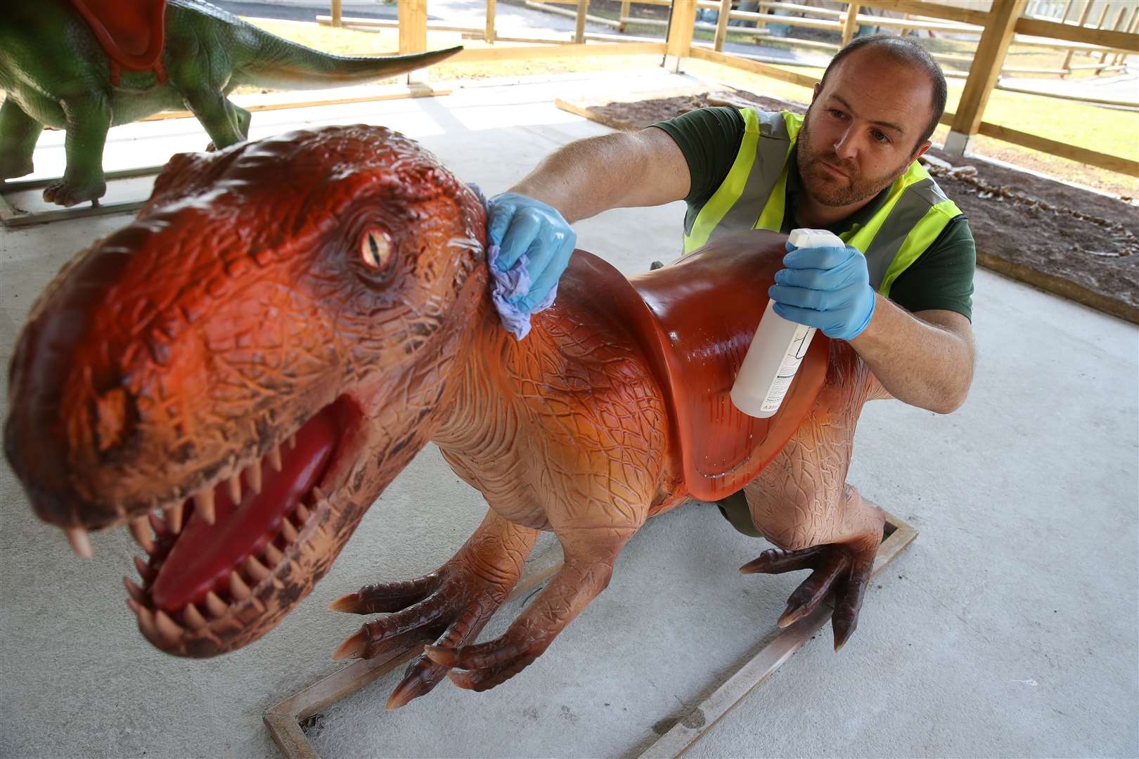 Mr Warren cleans an exhibit at the new World of Dinosaurs attraction (Andrew Milligan/PA)