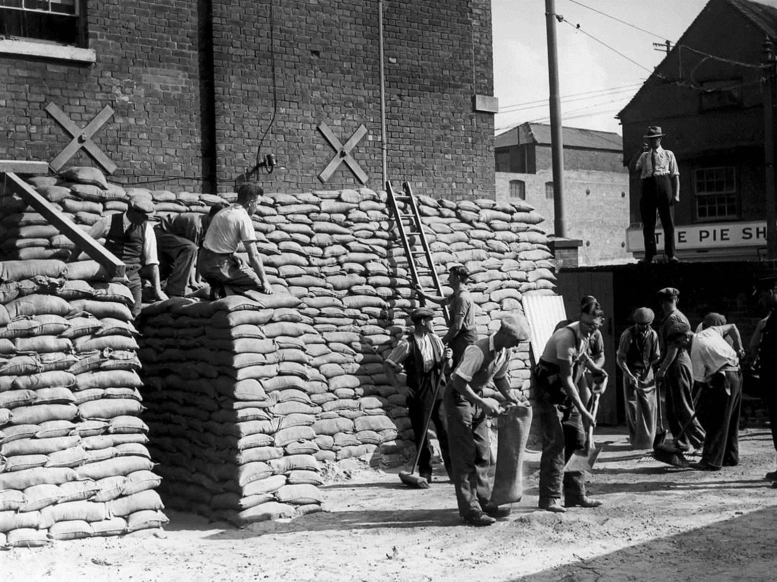 Sandbags being filled and placed into position at the former county police headquarters at Wrens Cross in Maidstone