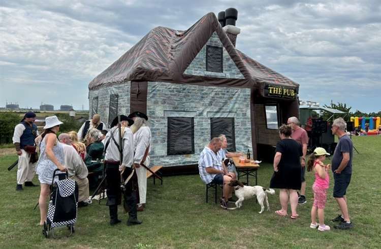 Villagers enjoy drinks at the inflatable pub in Allhallows