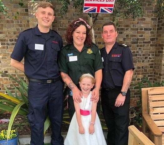 Firefighters James Knight and watch manager Marc Rustage and ambulance technician Charlotte Speers, pictured with five-year-old Lila Page from Rainham, who they helped rescue when she collapsed. Picture: Kent Fire and Rescue Service