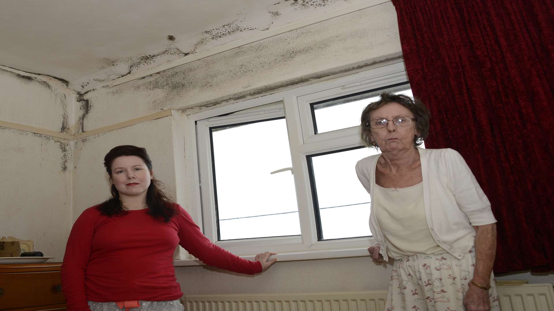 Tracy Quarrington and mum Margie in the main bedroom, where mould covers the coving and ceiling