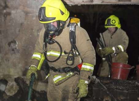Firefighters dampen down the blaze. Pic: Kent Fire and Rescue Service