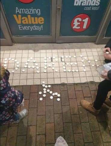 Candes were laid to spell out the name of Daren Glenister who worked at Poundland