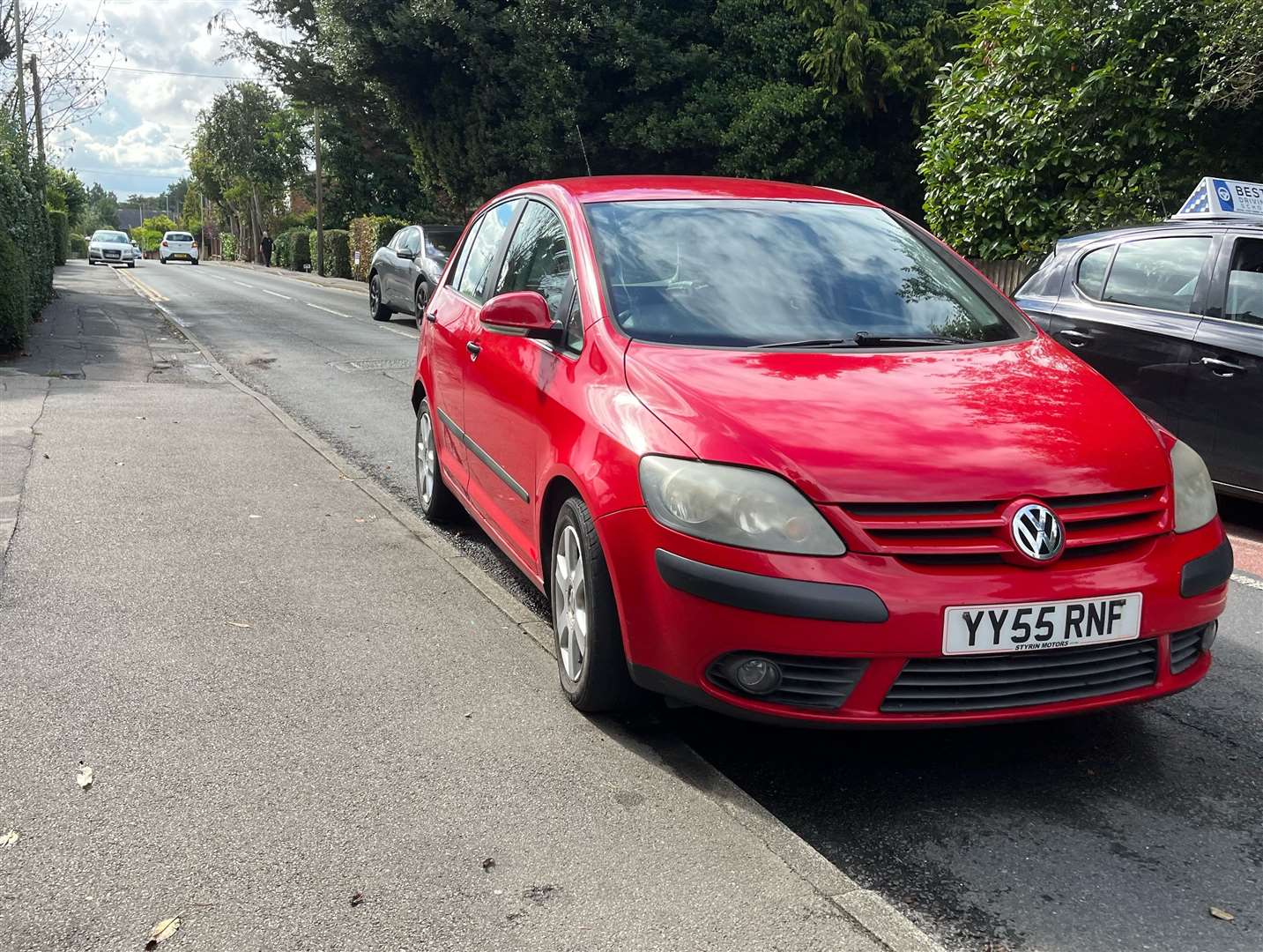 A red VW has been left at the roadside for weeks