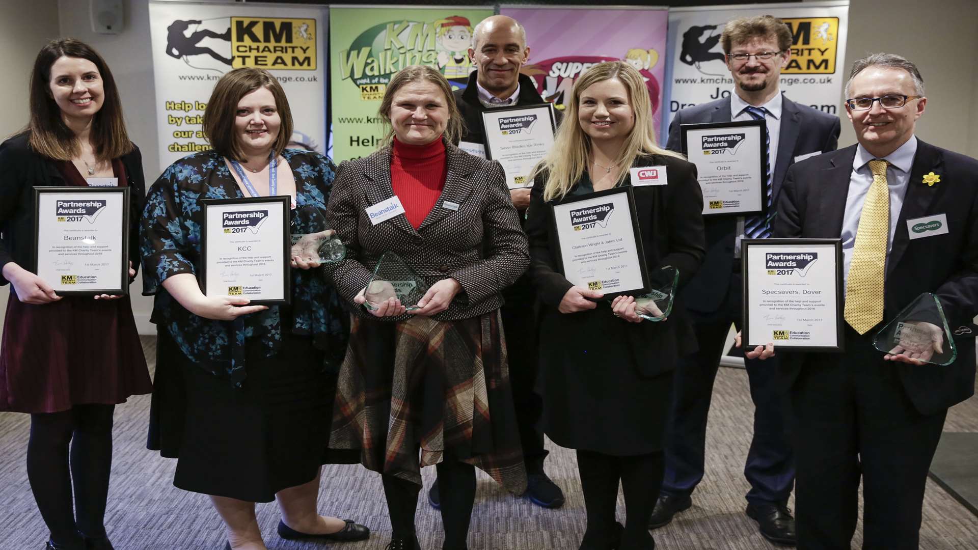 KM Charity Team present their Partnership Awards, thanking the many sponsors of their literacy schemes.