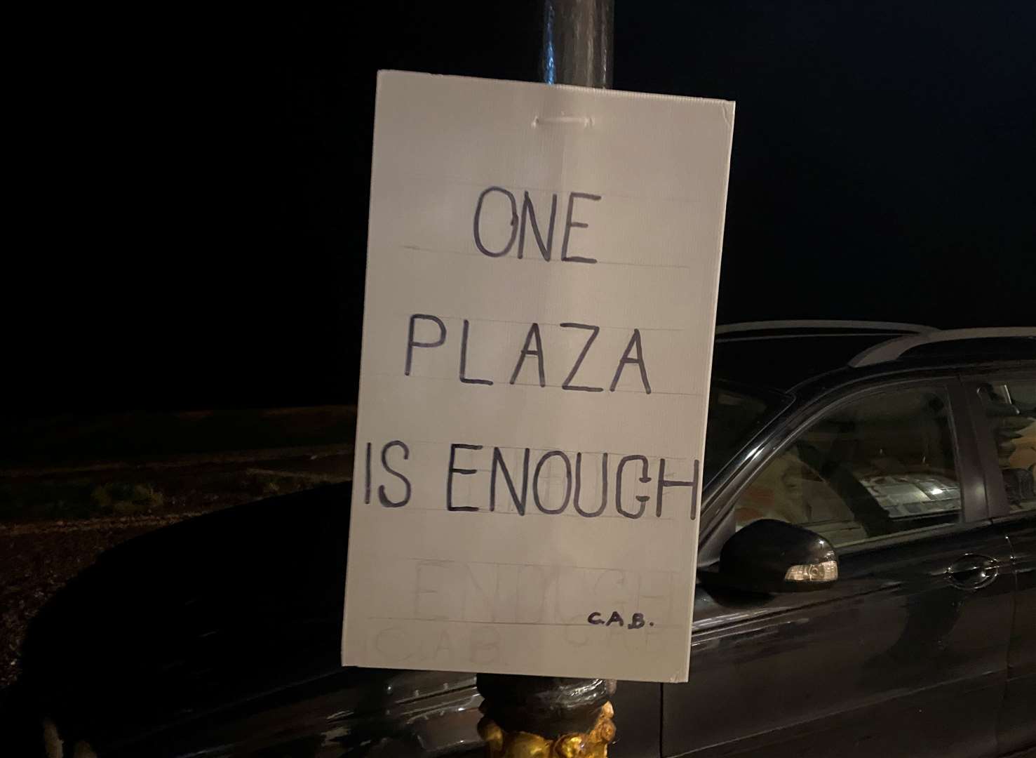 Posters were erected outside a town meeting held over a controversial new one-way system and seafront plaza in Herne Bay
