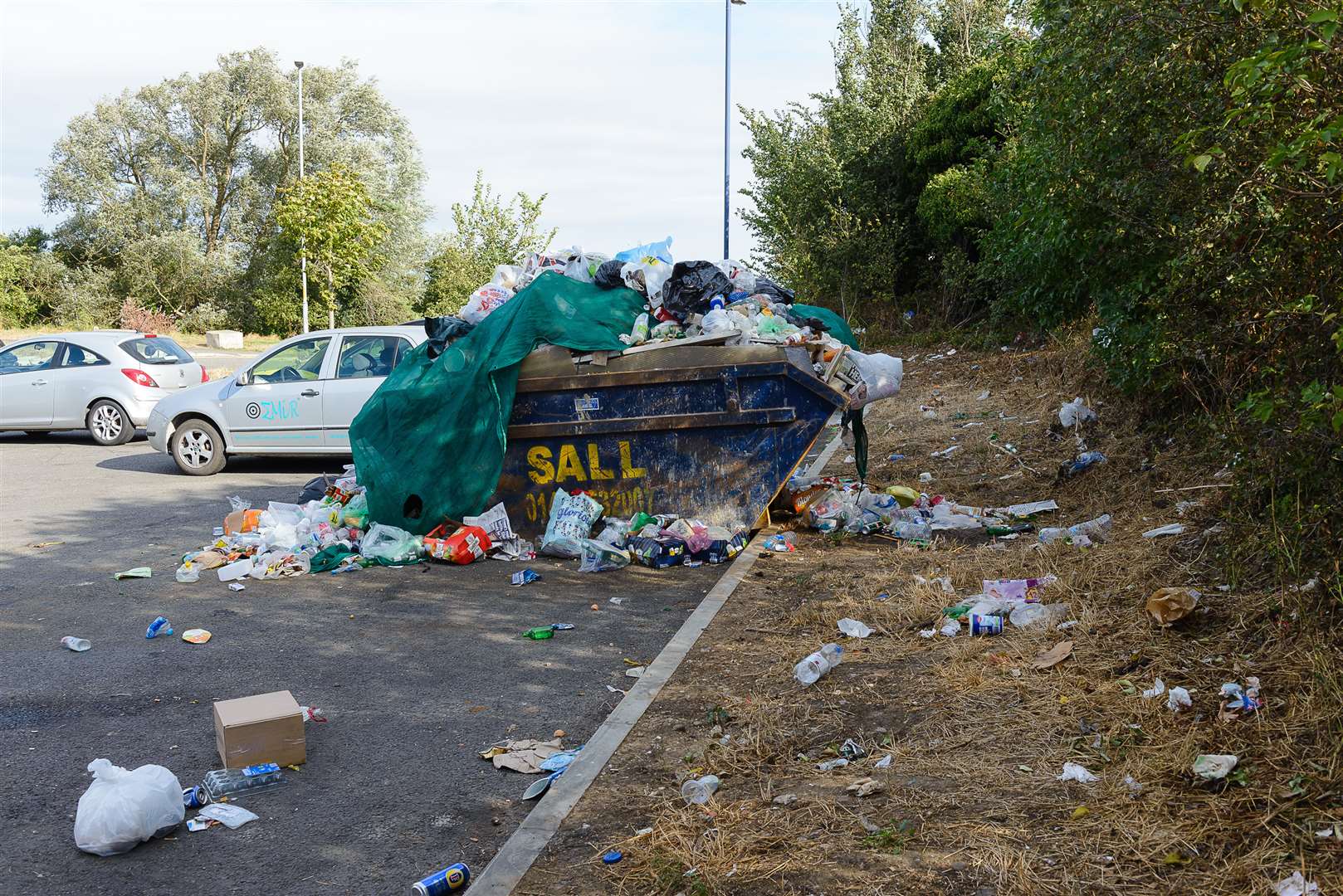 A skip at the lorry park overflowing with rubbish