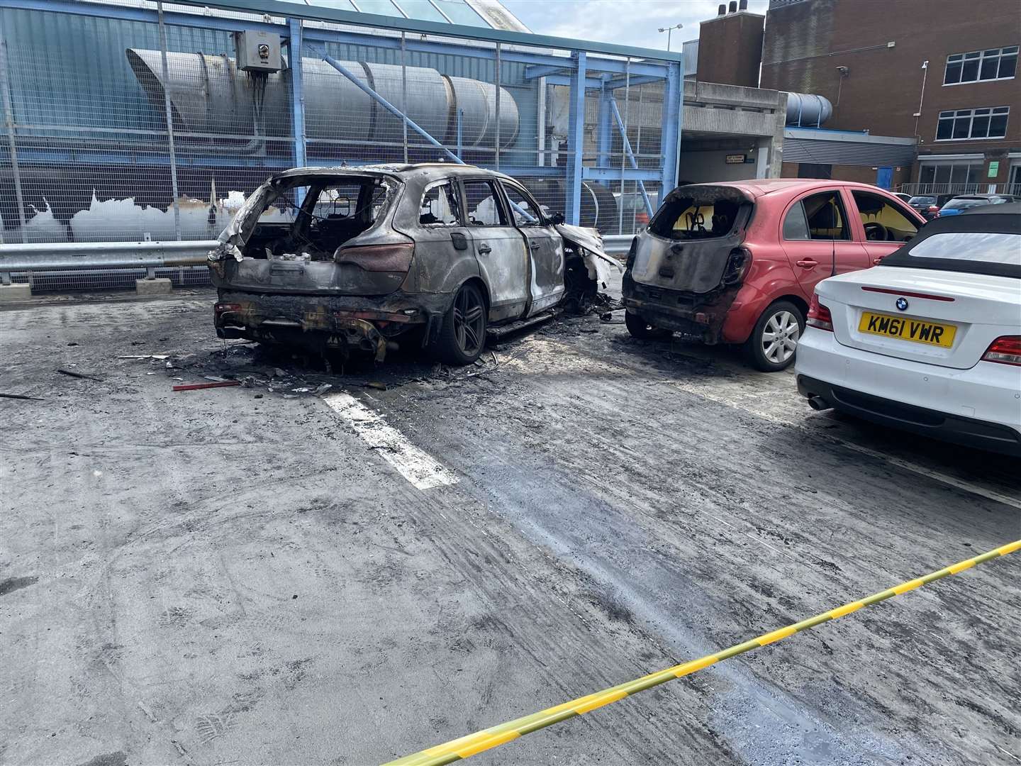 The burnt-out Audi and damaged Micra
