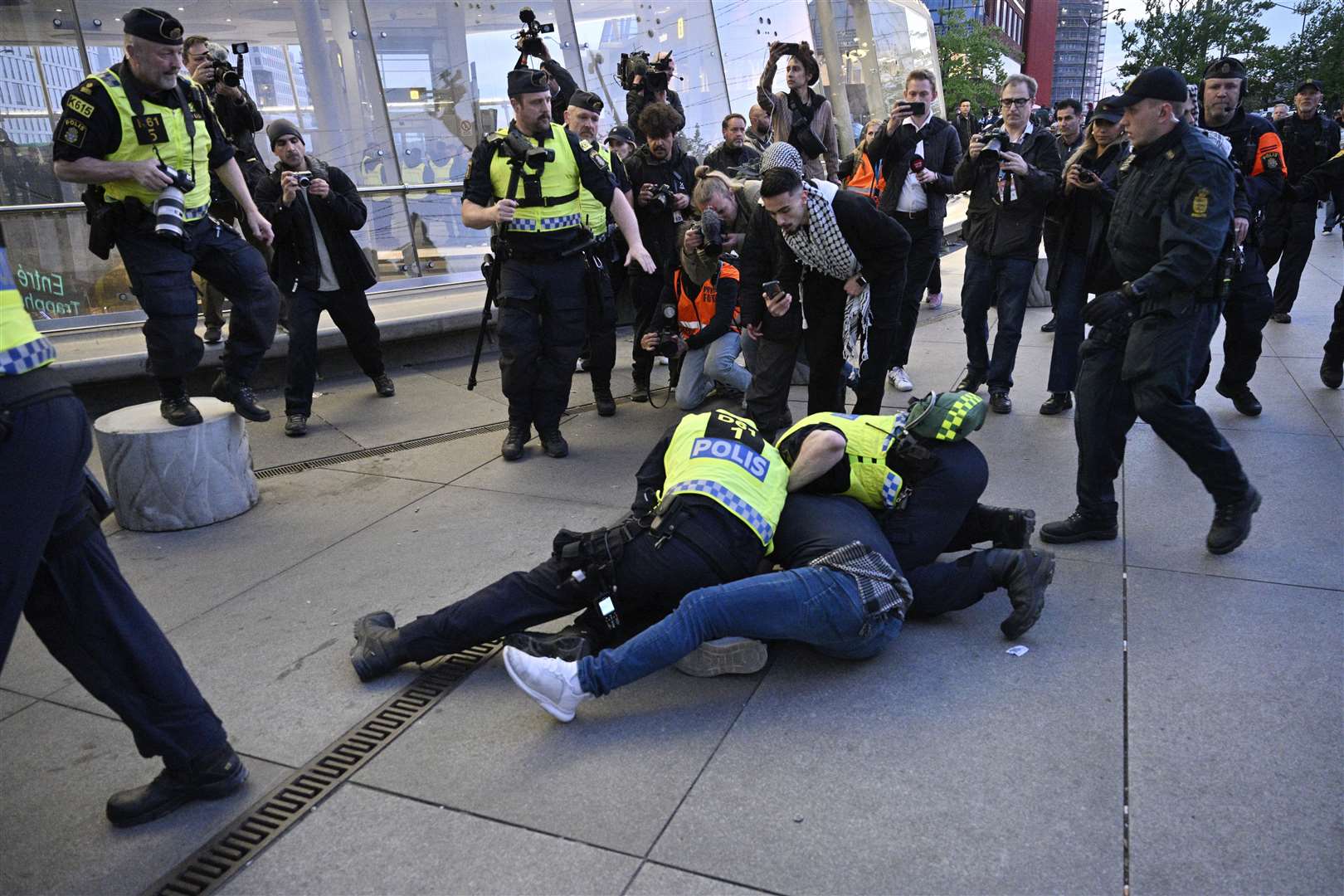 Police tackle a man during a protest against the participation of Israeli contestant Eden Golan ahead of the final of the Eurovision Song Contest in Malmo, Sweden (Johan Nilsson/TT News Agency via AP)