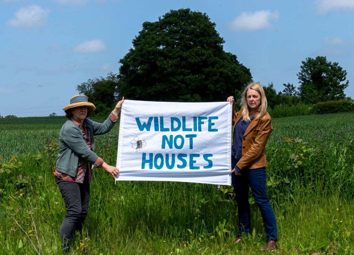 Protesters hold a banner saying “wildlife not houses”