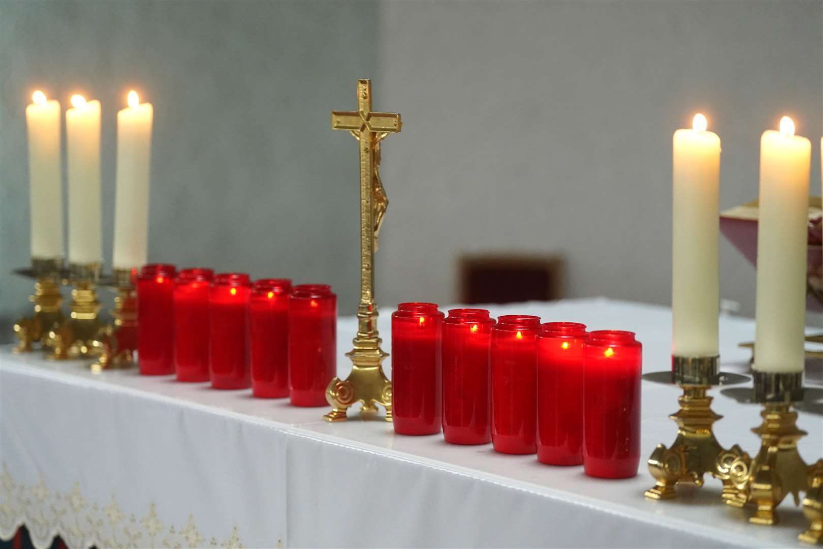 Ten red candles at St Michael’s Church in Creeslough – one for each victim of the Applegreen service station explosion (Brian Lawless/PA)