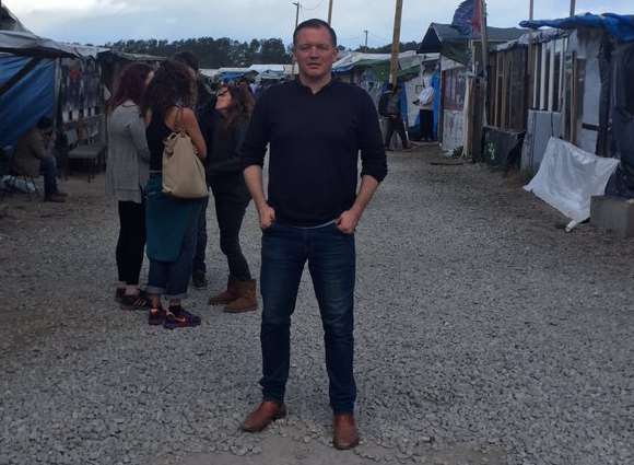 Folkestone & Hythe MP Damian Collins in the Calais camp