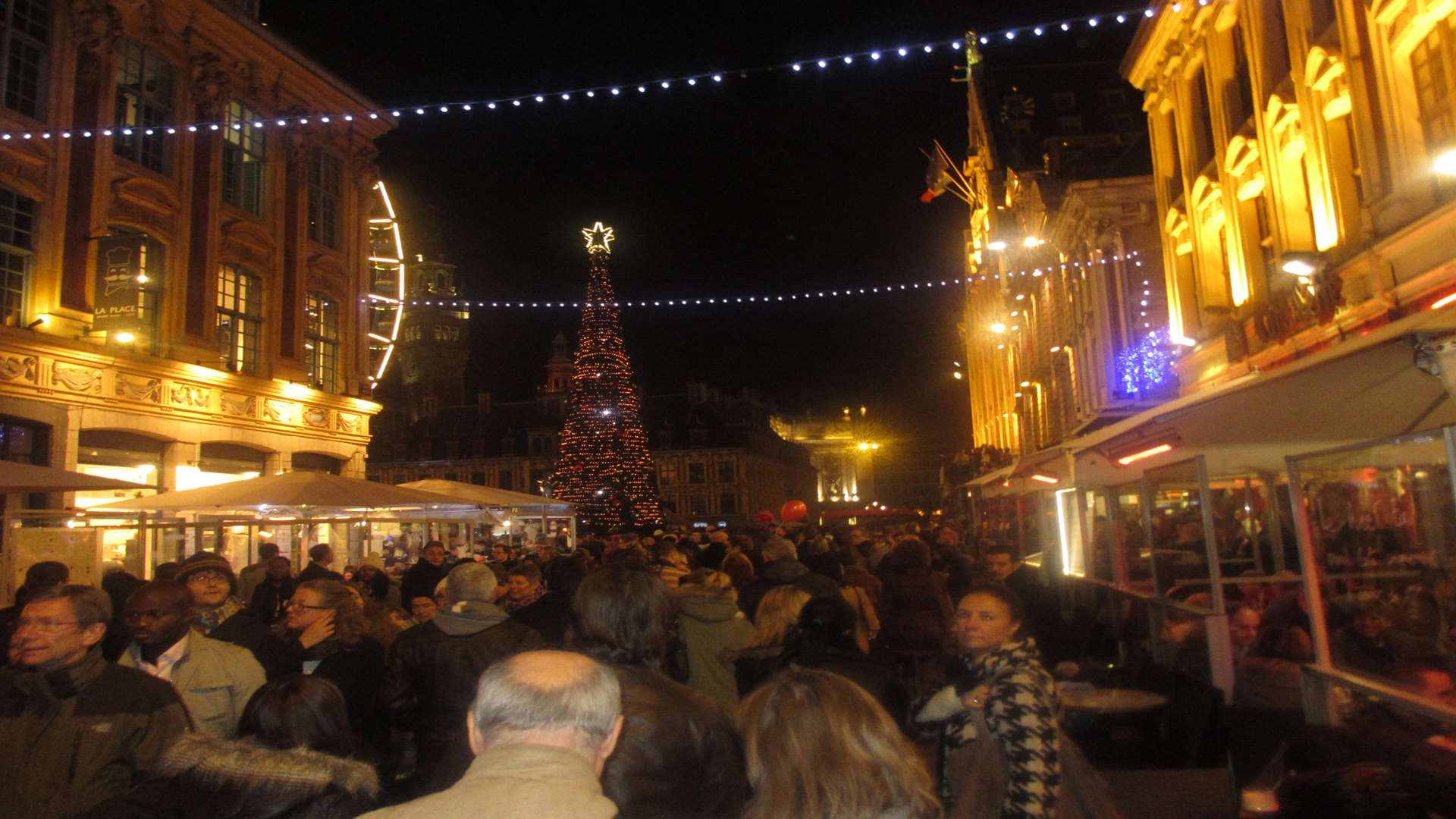 The festive crowds jostle for space as they make their way along the cobbled streets. Picture: Mike Rees