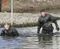 Officers search the water under a motorway crossing. Picture: PETER STILL