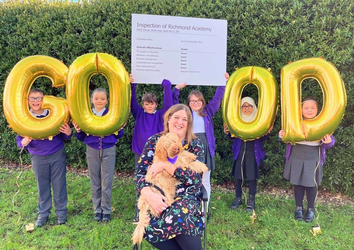 Head teacher Helen Evemy with Dudley the school dog and children, celebrating the first ‘Good’ Ofsted rating in Richmond Academy’s history