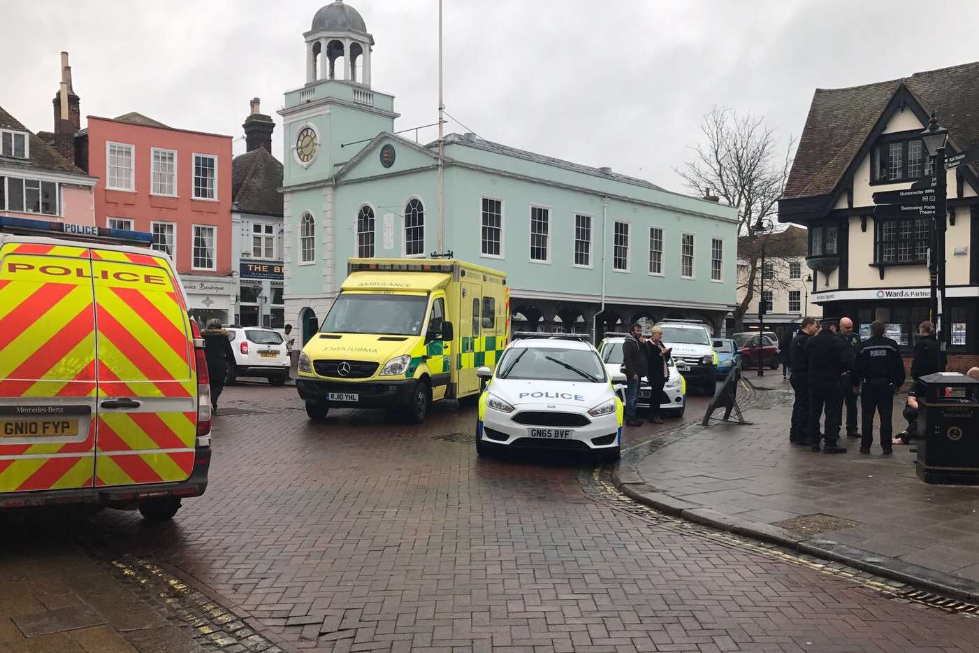 A number of police vehicles and an ambulance are in Market Place, Faversham.