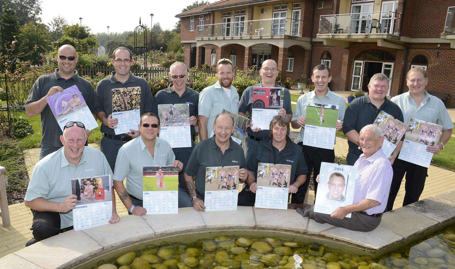 The drivers fully clothed with their calendar and Mark's dad Cliff Boulton (Seated right) at Ashford Pilgrims Hospice. Picture: Paul Amos