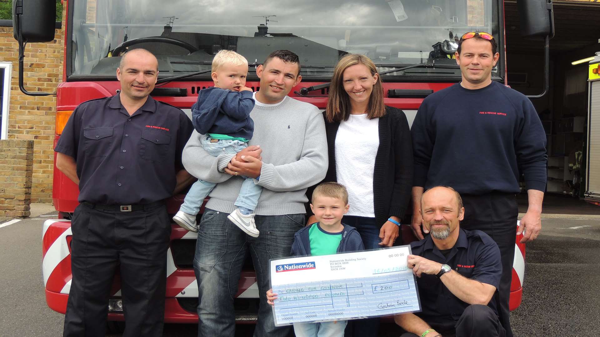Connor Olsen receives a donation on his visit to Margate Fire Station.