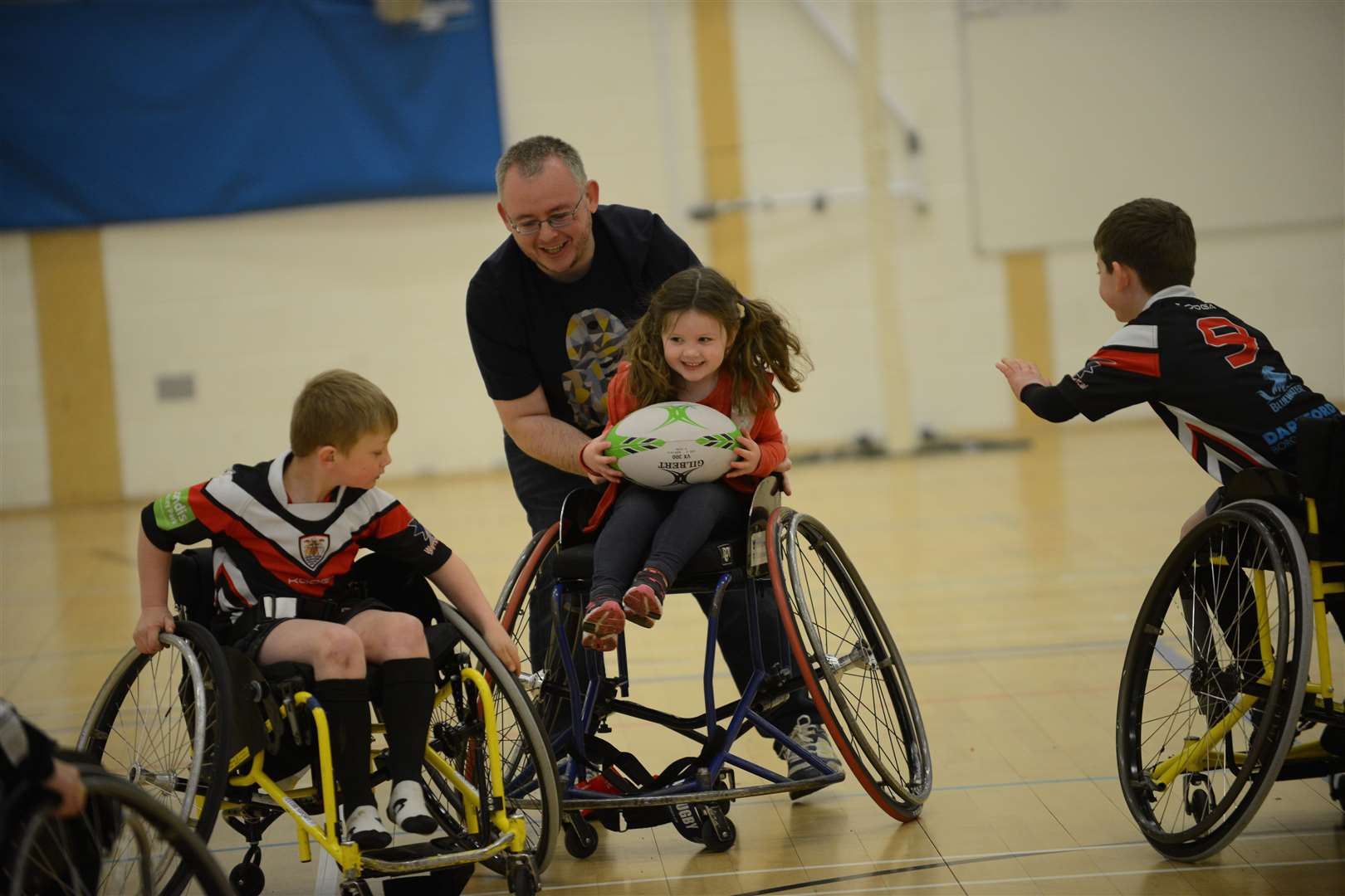 Richard Taylor and his daughter Jessica having a go at wheelchair rugby.