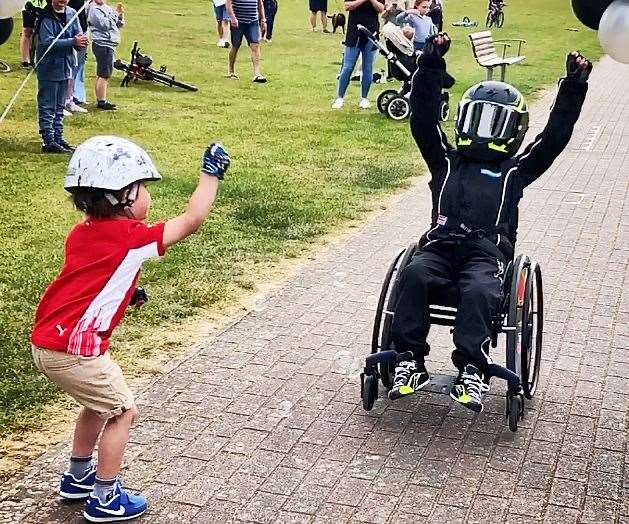 Matt finishing his final lap of his street in his wheelchair, raising nearly £1,500 for Whizz-Kidz