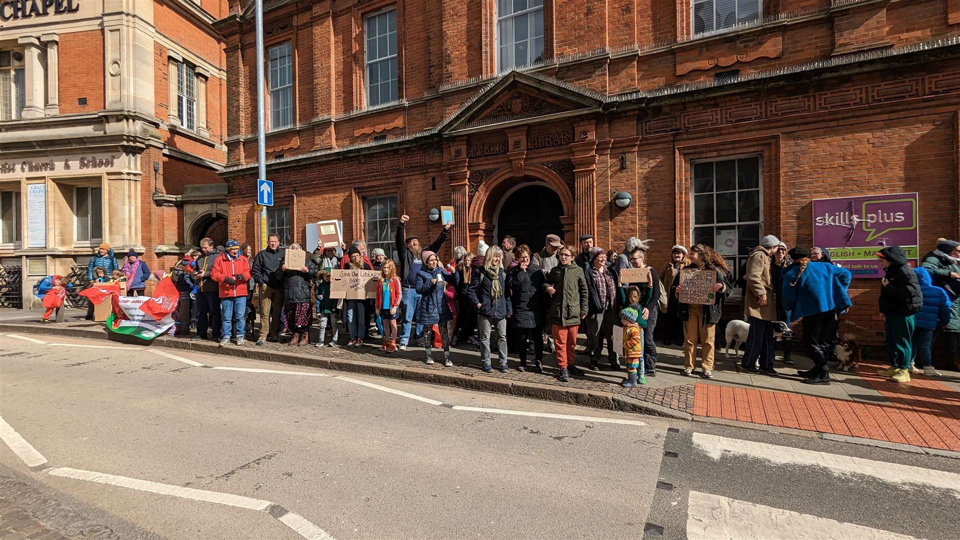 Folkestone residents have gathered outside the library to protest its closure