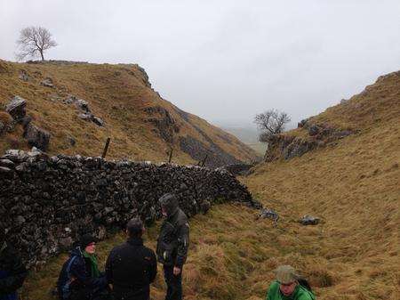 Walkers brave the rugged landscape of the Yorkshire Dales.