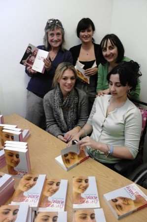 Nicole Dryburgh signing copies of her book with Maureen Smith, Victoria Stonex (Hodder publishing) Jackie Dryburgh and, seated, Nikki Groom who is Nicole's communicator. Picture: Chris Davey