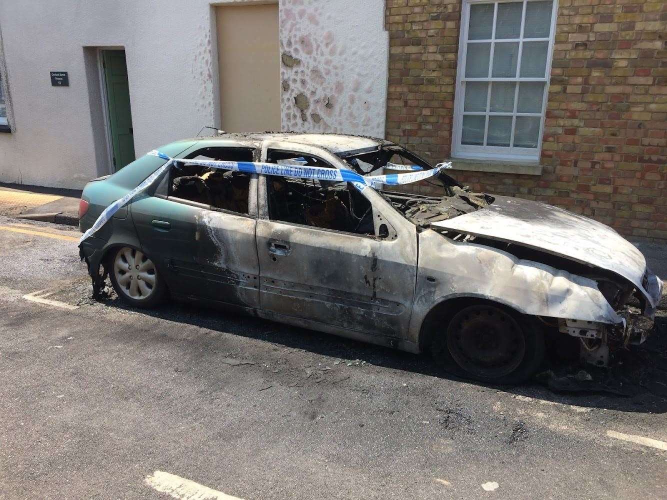 A burnt-out car in Church Street, St Dunstans, this morning