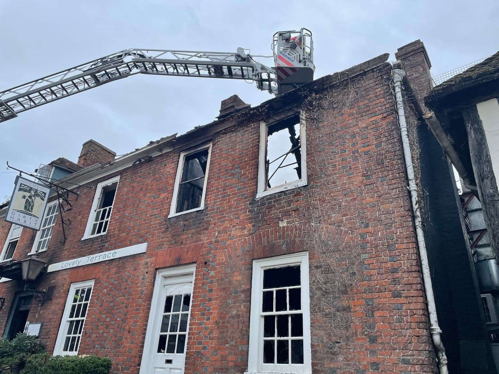 Firefighters survey the damage at the Dirty Habit in Hollingbourne. Picture: Sean McPolin