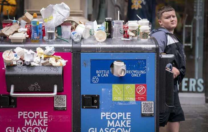 Bins in Glasgow are overflowing after the strike by council waste workers spread. Picture: PA