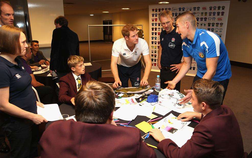 Prince Harry chats to youngsters during a rugby-inspired fun day at Twickenham