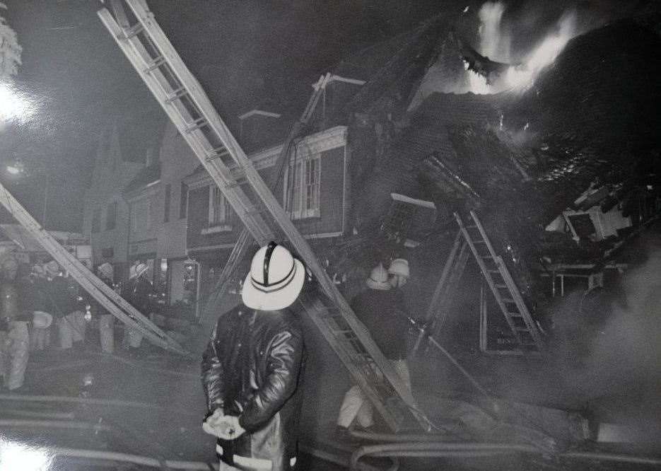 A firefighter watches the flames rage on