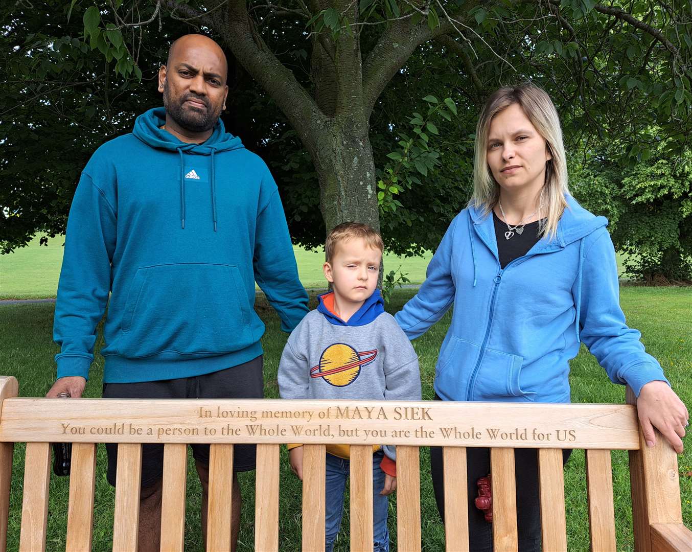Rajratan Bande, Magdalena Wisniewska and their son Nathan, with the bench dedicated to Maya