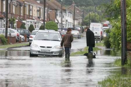 Dogwalkers brave the flood waters in Holmside Avenue, Halfway