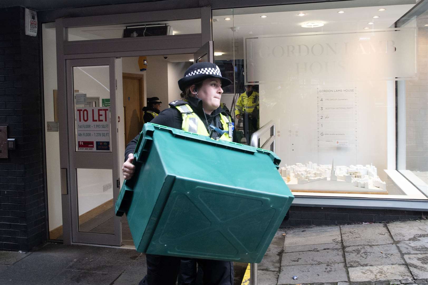 A police officer removing material from SNP headquarters in Edinburgh last April (Lesley Martin/PA)