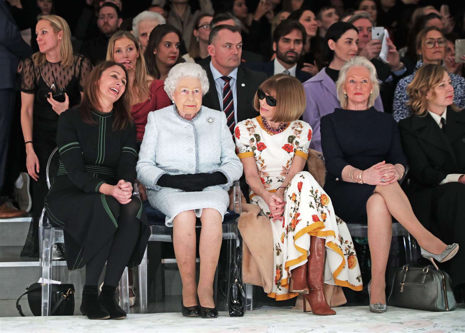 The Queen sits with Anna Wintour and royal dressmaker Angela Kelly (second right) at London Fashion Week (Yui Mok/PA)