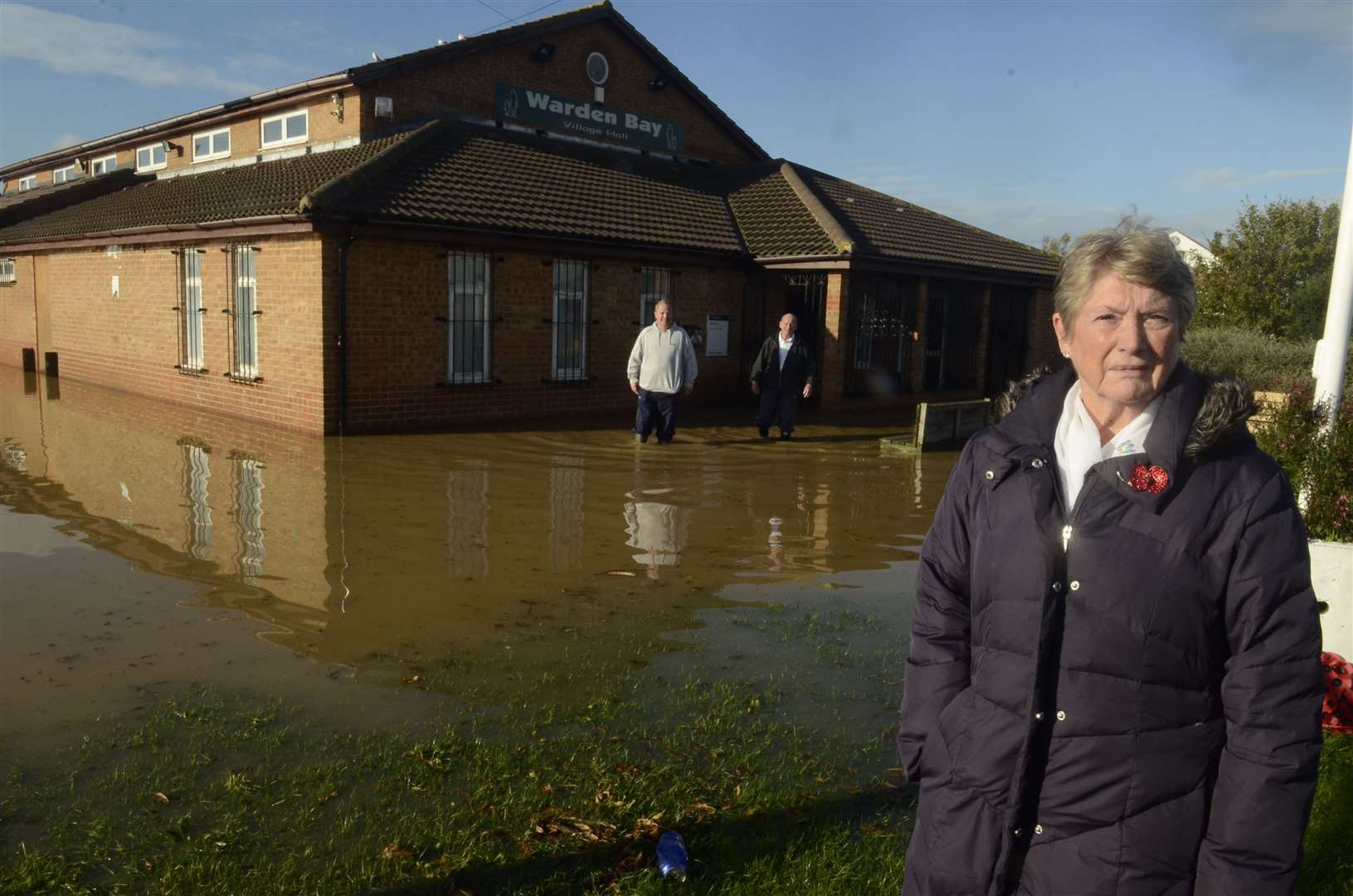 Cllr Pat Sandle outside a flooded Warden Bay Village Hall in 2014