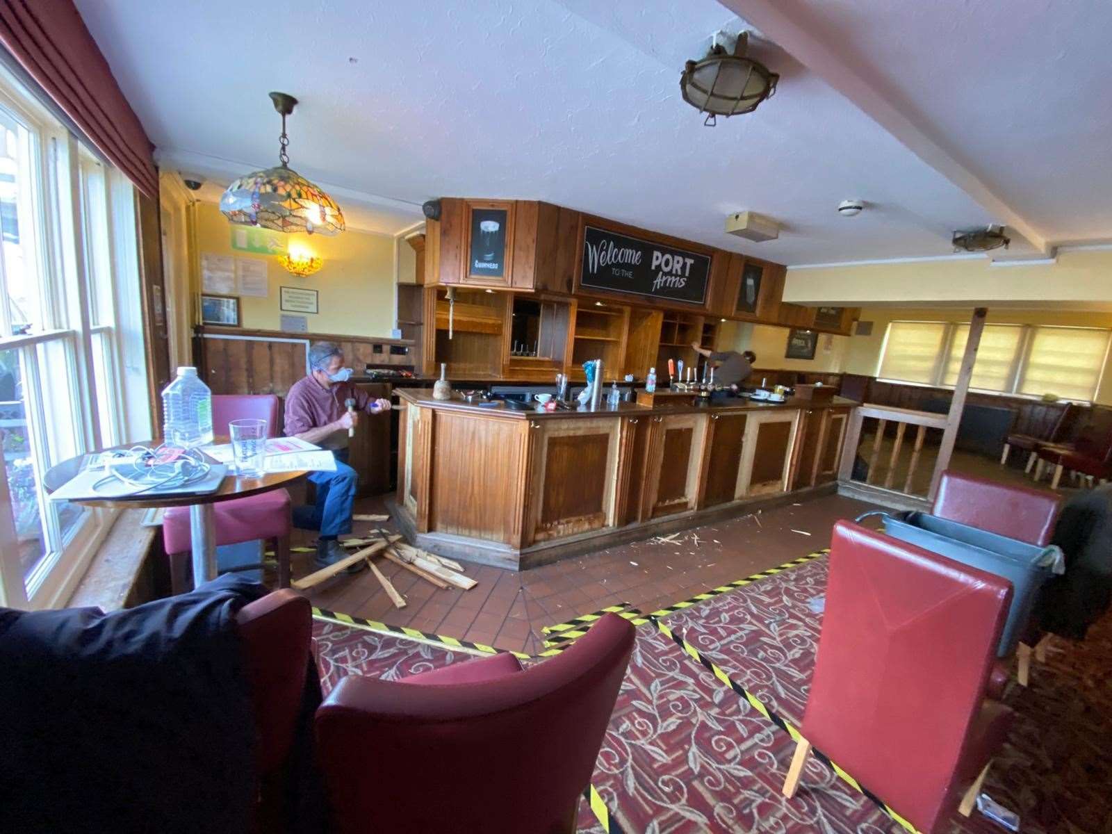 The old carpet inside the Port Arms has been pulled up and the bar is being modified