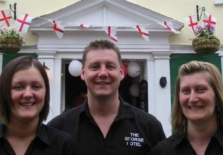 George Hotel publican Tom Dixon with barmaids Corinna Andeson, left, and Tracey Powell