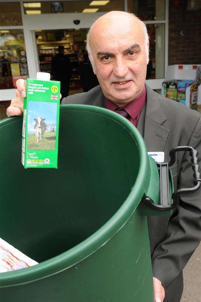 Co-op manager Mujdat Gulum with the Foodbank collection bin now in the Deal store